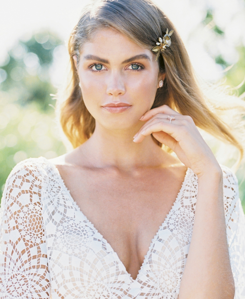 Casablanca’s “Cheyenne” laser-cut lace and stretch satin georgette gown from Palmetto Bridal Boutique. Gold hairpin by Emma Katzka.  Opal and diamond earrings and morganite and diamond rose gold ring, both from Gold Creations. Location: Seabrook Island Club Equestrian Center. Photograph by Perry Vaile