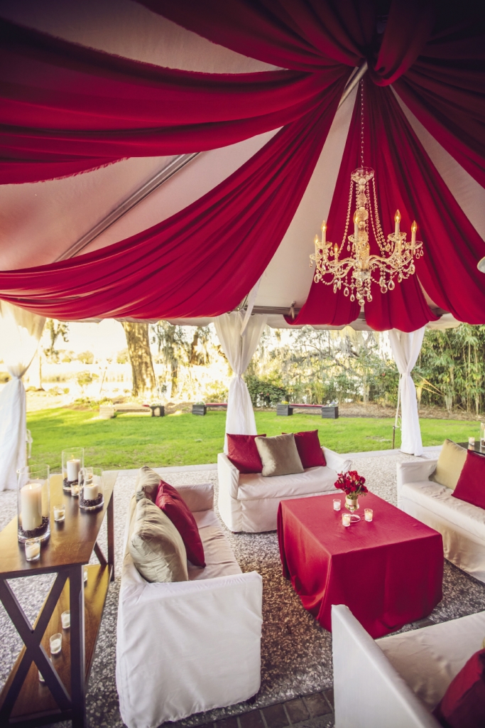 COLORFUL CANOPY: Cindy Zingerella of Engaging Events used swaths of red fabric and a crystal chandelier to give the lounge an upscale, finished look.