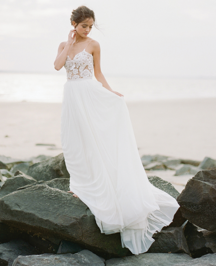 Beach Brides: “Dahlia” midi dress with tulle skirt overlay from Emily Kotarski Bridal Studio and Showroom. Why It Works: “Switch up the formal look of ‘Dahlia’ by adding a flowing tulle skirt and you exude major beach wedding vibes.” —Emily Kotarski