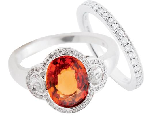 Hans D. Krieger’s 18K white gold spessartite garnet and diamond ring ($5,825) and 18K white gold and diamond band (price on  request), both from Paulo Geiss Jewelers