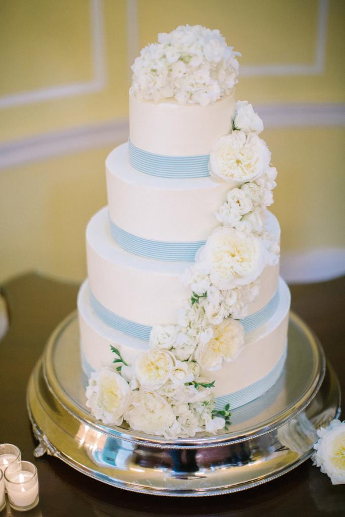 Cake by Patrick Properties Hospitality Group. Florals by Tiger Lily Weddings. Image by Clay Austin Photography.
