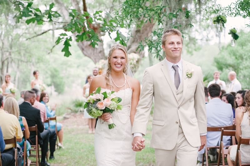 Florals by First Bloom of Charleston. Bride’s gown by WTOO through Bridals by Jodi. Groom’s attire by Men’s Wearhouse. Image by Britt Croft Photography.