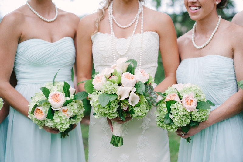 Bouquets by First Bloom of Charleston. Bridesmaid attire through Bella Bridesmaids. Bride’s gown by WTOO through Bridals by Jodi. Image by Britt Croft Photography.