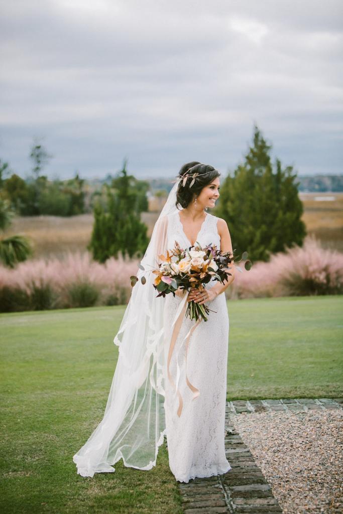 Bride&#039;s gown by Watters from Jean&#039;s Bridal. Veil from Bridal House of Charleston. Hair by Studio 285 and MW Salon. Makeup by Dannon K. Collard and BeautiControl. Hair accessory, bouquet, and photograph by Mark Williams Studio.