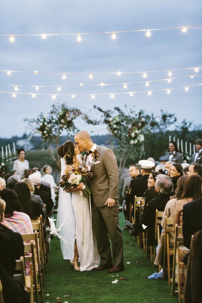 Bistro lights from Charleston Uplighting. Wedding design, florals, and photograph by Mark Williams Studio at the Daniel Island Club.