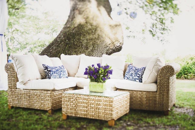 SIT BACK: Comfy wicker furniture and custom-made throw pillows gave the outdoor lounge areas a homey feel.