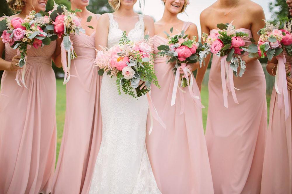Bride&#039;s gown by Marisa Bridals. Bridesmaid dresses by Watters, available locally through Bella Bridesmaids. Bouquets by Branch Design Studio. Photograph by Juliet Elizabeth.
