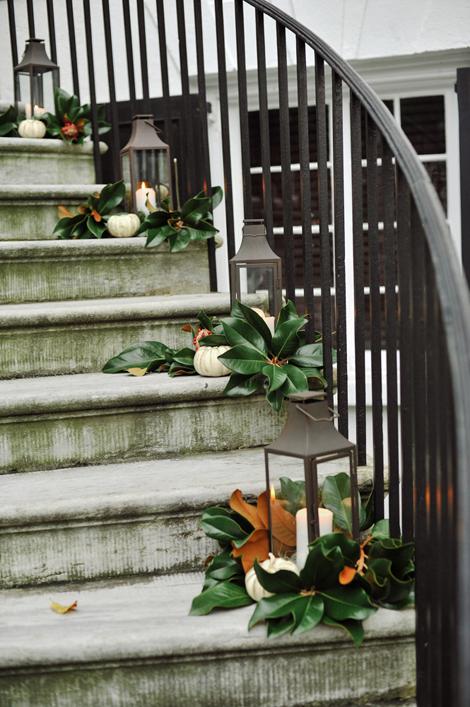 RIGHT THIS WAY: Reflecting the evening&#039;s palette, fresh magnolia blooms, cream-colored pumpkins, and pewter lanterns lined the spiral staircase leading to the reception venue&#039;s spacious piazza.